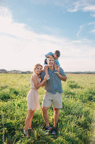 Happy family in park in sunny summer day