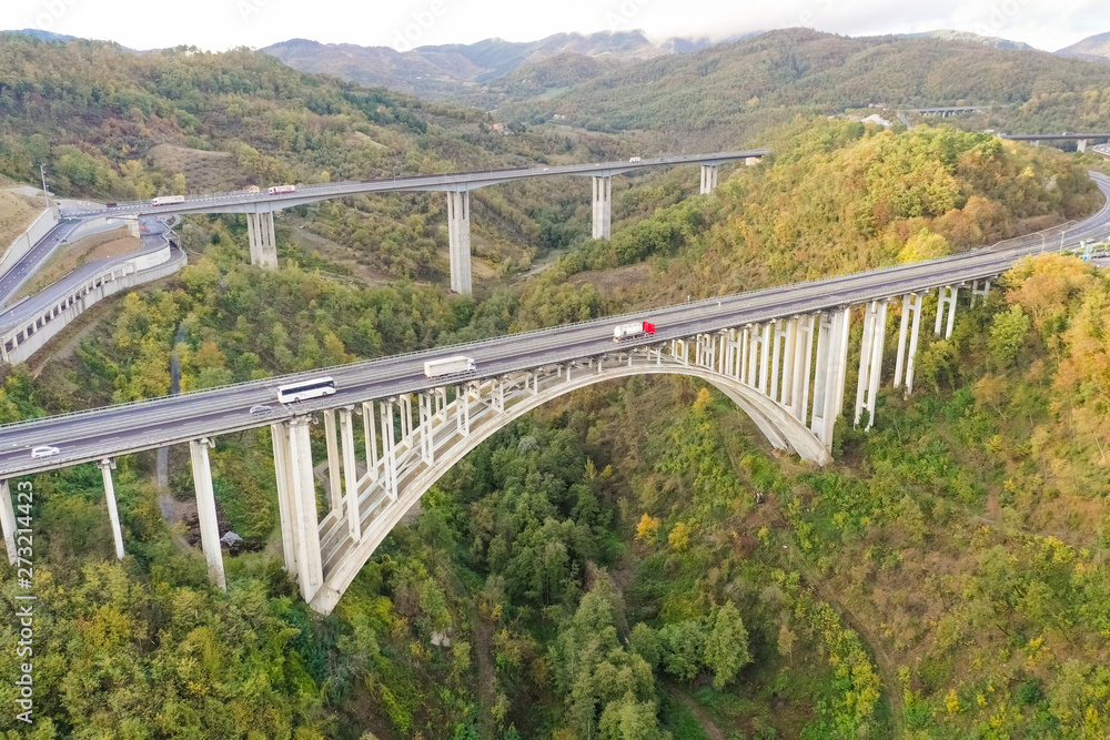 Aerial view of arch bridge crossing mountain region, Italy. Aerial view of arch bridge crossing mountain region, Italy.