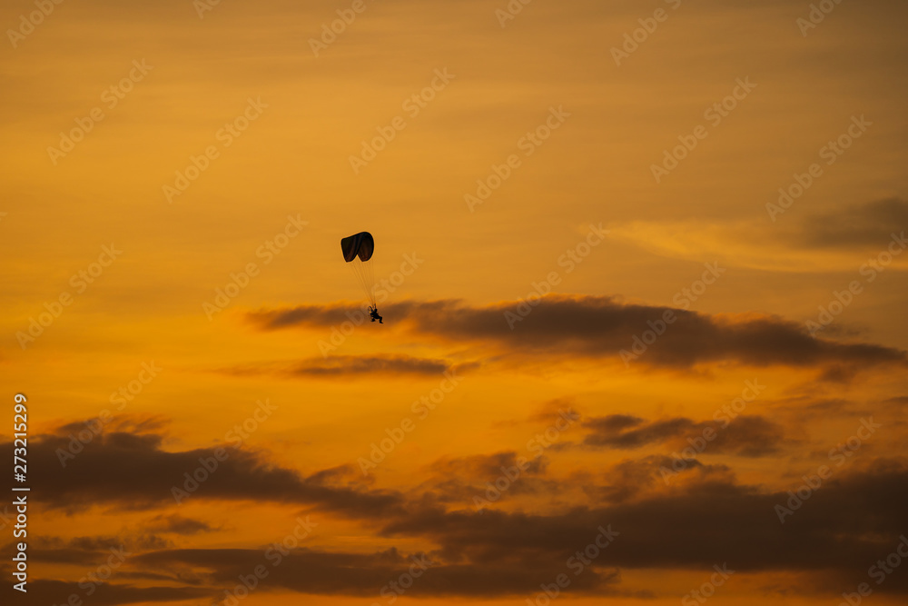 The silhouette of the paramotor at sunset