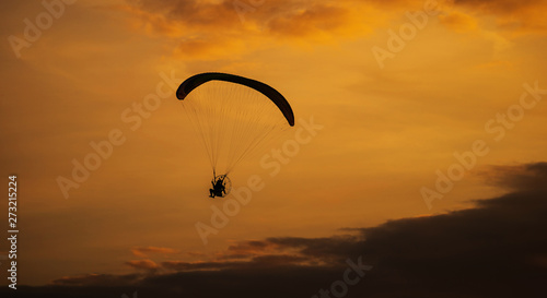 The silhouette of the paramotor at sunset