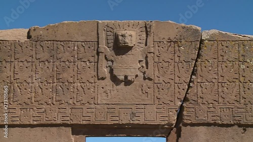 Close-up low angle panning shot of the detailed stone carvings on the Gate of the Sun, La Paz, Bolivia