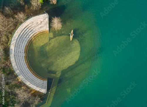 Aerial view of person kayaking next to old amphitheater at beautiful lake Plastira in Greece photo