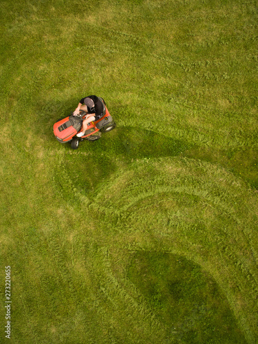 Aerial view of a man mowing the lawn creating shapes. photo