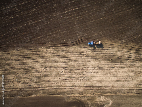 Aerial view of a tractor working on the farmland in Estonia.