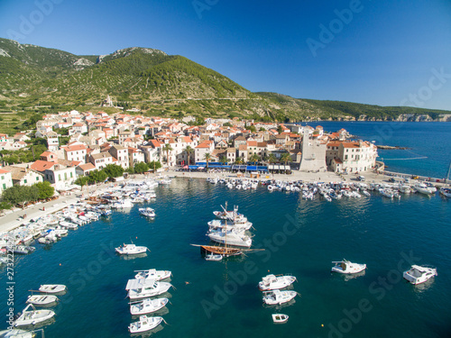 Aerial view of Komiza town and boats docked in marina on Vis Island, Croatia. photo