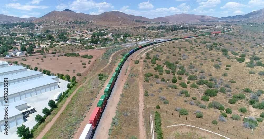 Drone 4K video of a long locomotive going through the mountains in Acton California Drone 4K video of a long locomotive going through the mountains in Acton California