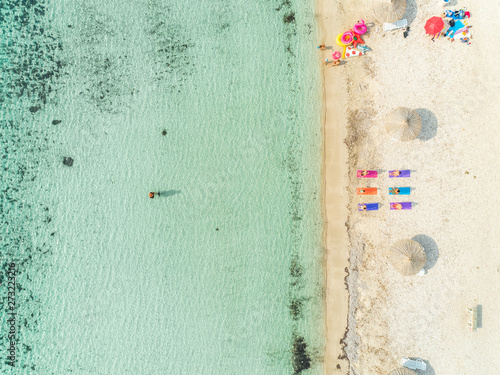 Aerial view of yoga group on sandy beach in summer with inflatable matresses. photo