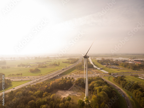 Aerial view of wind turbine spinning during beautiful day, Deventer, Netherlands. photo