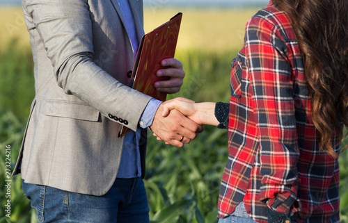 Farmer and businessman shaking hands