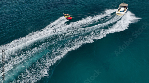 Aerial photo of extreme powerboat donut watersports crusing in high speed in tropical turquoise bay