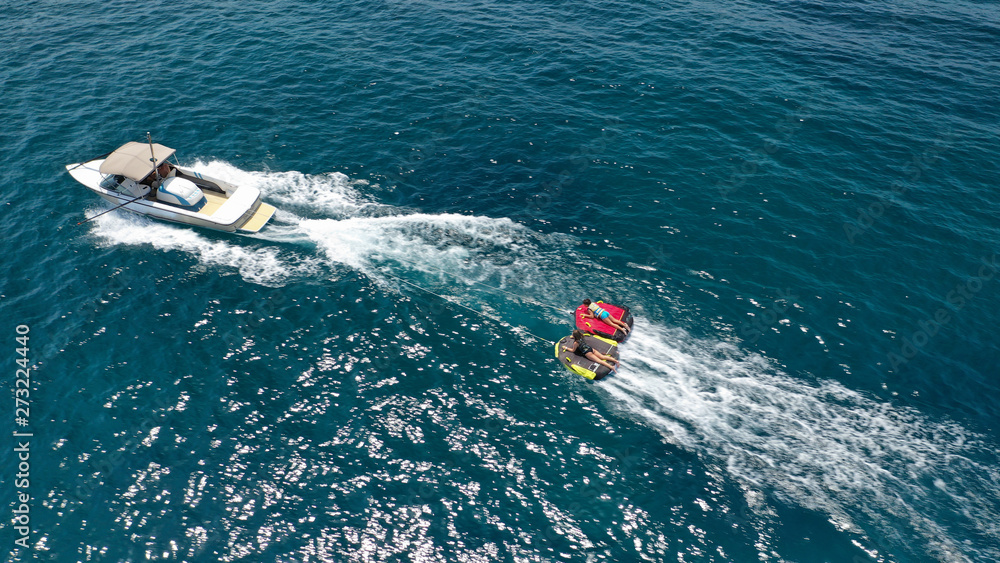 Obraz premium Aerial photo of extreme powerboat donut watersports crusing in high speed in tropical turquoise bay