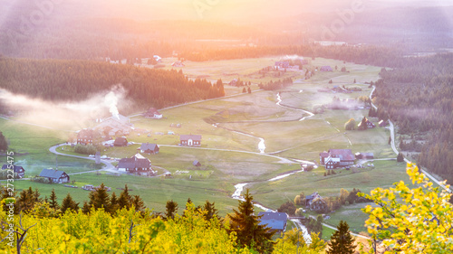 Jizerka village at sunset time. View from Bukovec Mountain, Jizera Mountains, Czech Republic photo