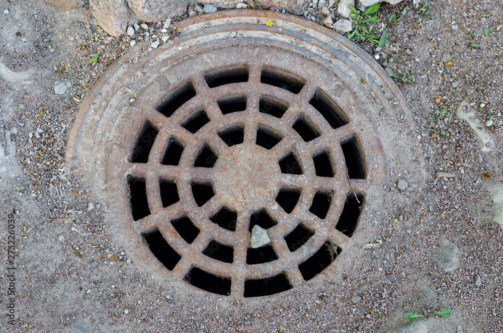The metal vintage rusty manhole