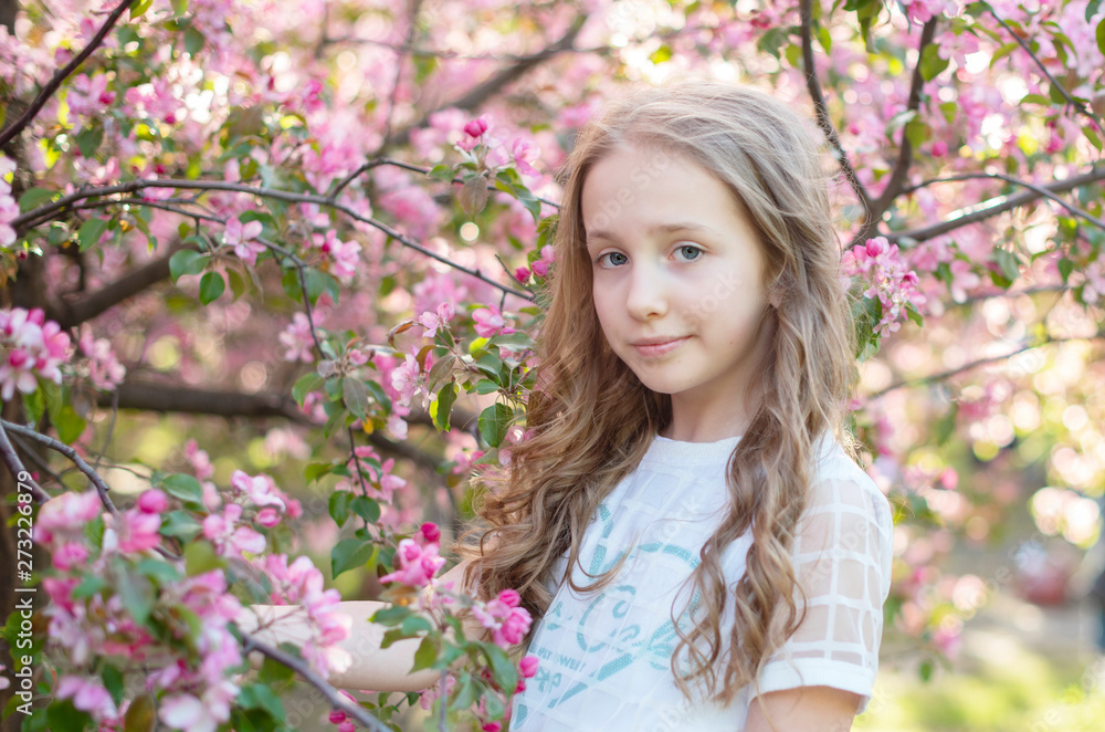 teen girl near the blossoming apple trees teen girl near the blossoming apple trees