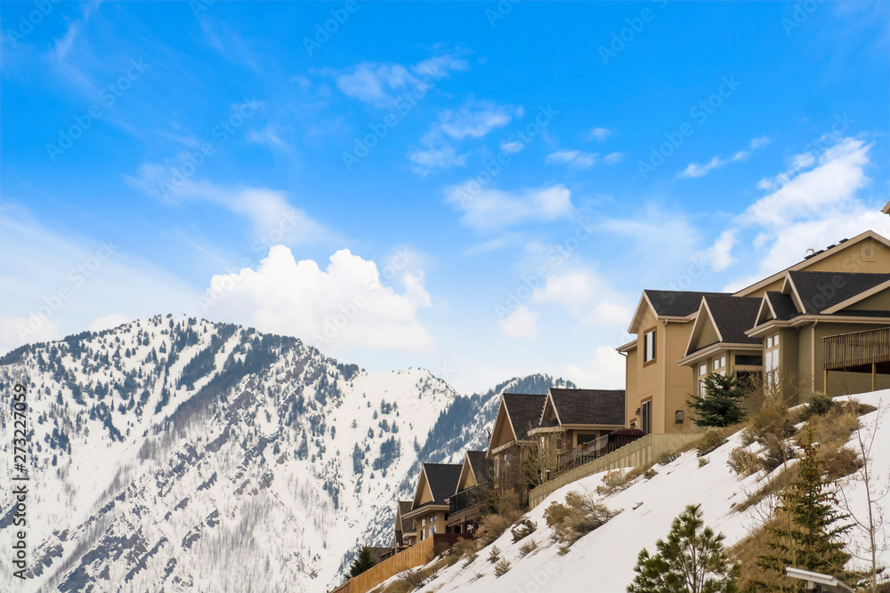 Houses built on top of a mountain blanketed with snow in winter