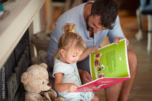 Father with child looking picture book