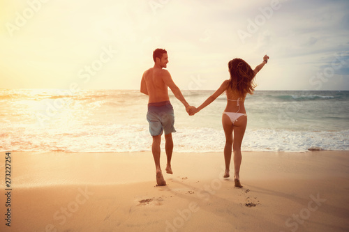 Young couple running on the beach