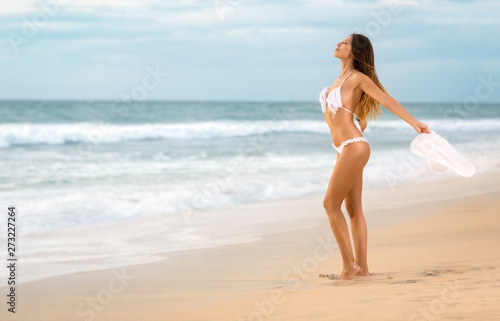 women on the sunny tropical beach in bikini