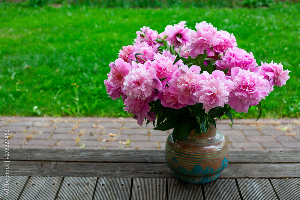 bouquet of peonies in vase in garden bouquet of peonies in vase in garden