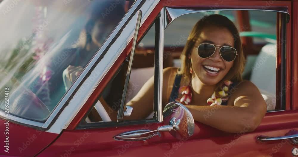 Young attractive woman sitting and smiling in a red vintage beach ...