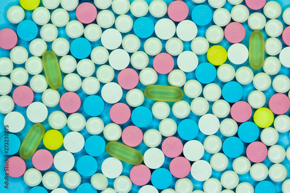 Colorful white, blue pink, yellow and green pills and tablets. Medical background. Colorful white, blue pink, yellow and green pills and tablets. Medical background.