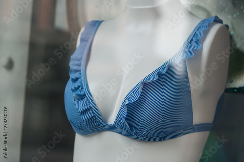 closeup of blue stripped bikini on mannequin in fashion store showroom for women photo