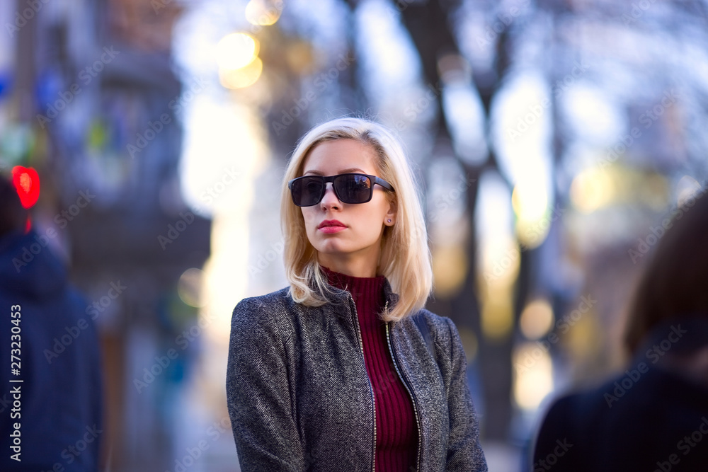 .beautiful blonde walks around the city, fashion image