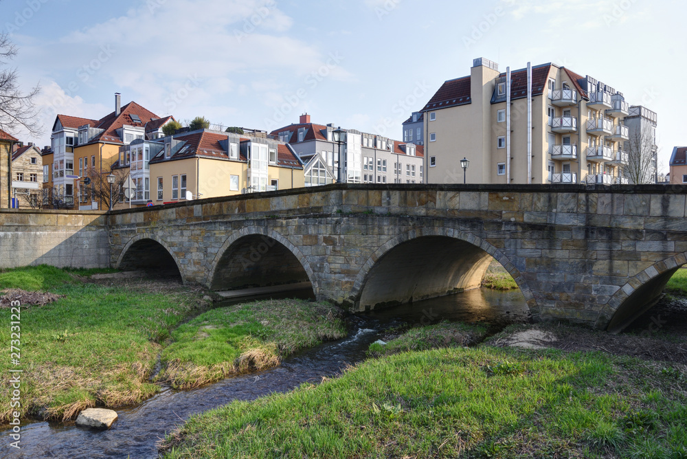 old bridge over the river Mistelbach in Bayreuth in back lit