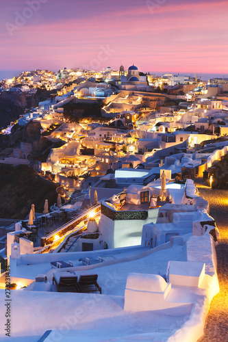  Unique view for the sunset over Oia  Santorini  a small  beautiful village on the edge of the caldera  Greece