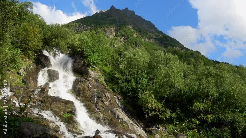 View waterfall scenes in mountains, national park Dombai, Caucasus, Russia. Summer landscape, sunshine weather and sunny day View waterfall scenes in mountains, national park Dombai, Caucasus, Russia. Summer landscape, sunshine weather and sunny day