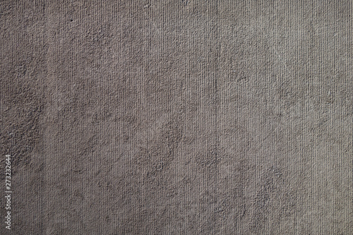 grey stucco wall background with vertical line marks