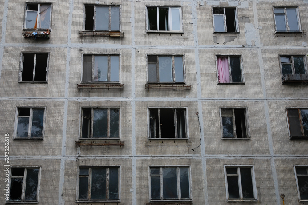 Abandoned house with broken windows and left things, depressive urban background