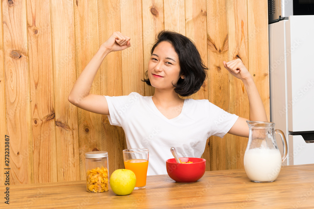 Asian young woman having breakfast milk celebrating a victory Asian young woman having breakfast milk celebrating a victory