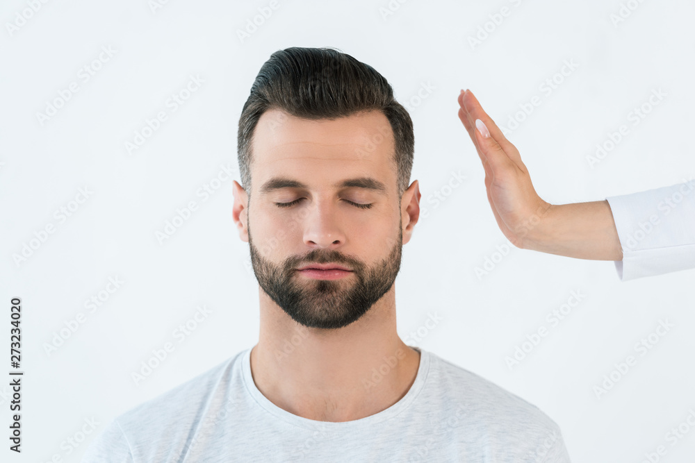 cropped view of woman healing handsome man isolated on white cropped view of woman healing handsome man isolated on white