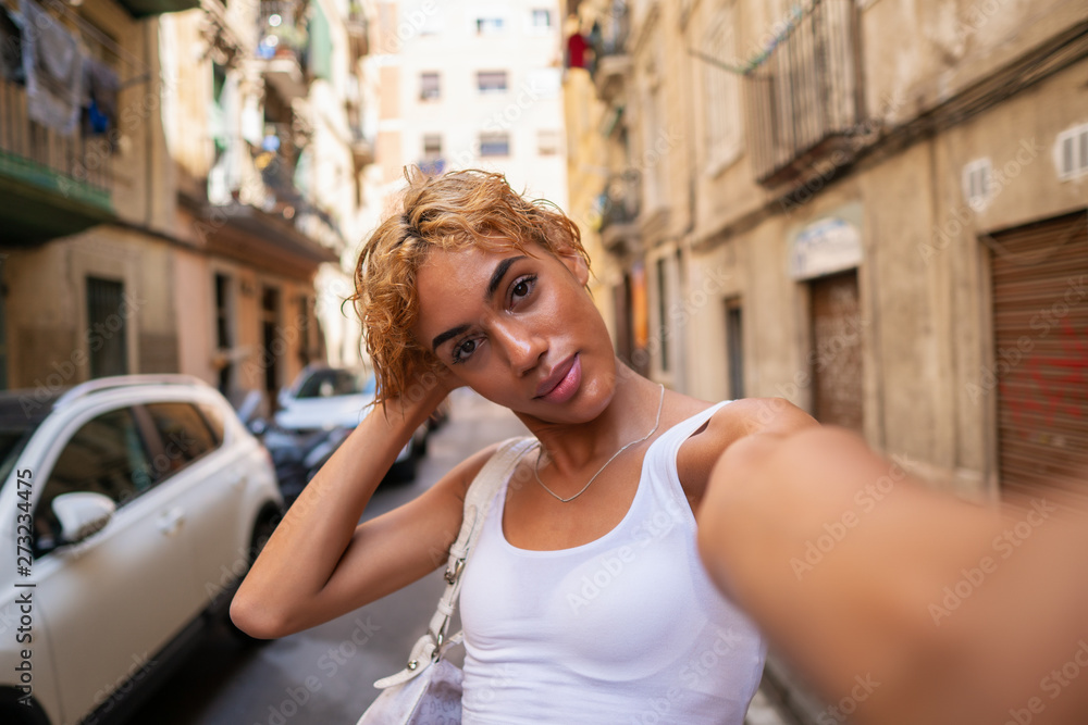 Beautiful transsexual woman posing in the city and doing selfie. Modern  city Stock Photo | Adobe Stock