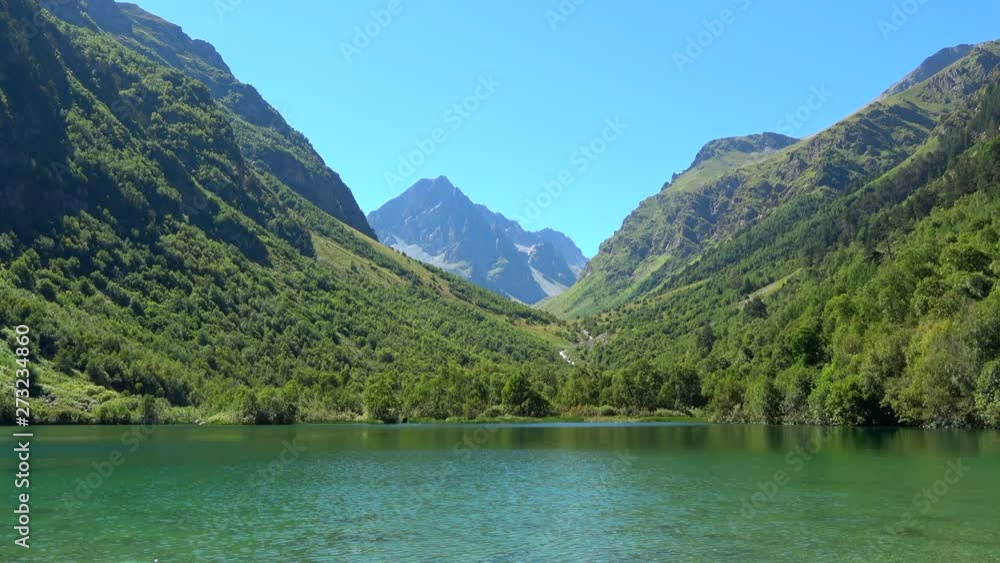 View lake scenes in mountains, national park Dombai, Caucasus, Russia, Europe. Summer landscape, sunshine weather, blue sky and sunny day View lake scenes in mountains, national park Dombai, Caucasus, Russia, Europe. Summer landscape, sunshine weather, blue sky and sunny day