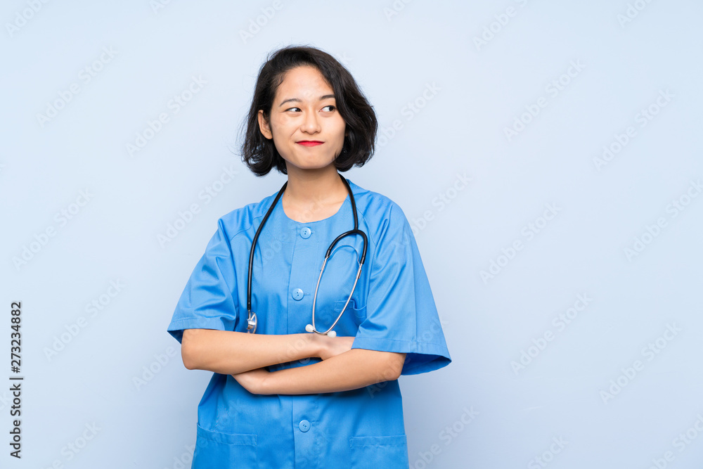 Surgeon doctor woman making doubts gesture while lifting the shoulders Surgeon doctor woman making doubts gesture while lifting the shoulders