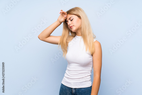 Teenager girl over isolated blue background intending to realizes the solution while lifting a finger up