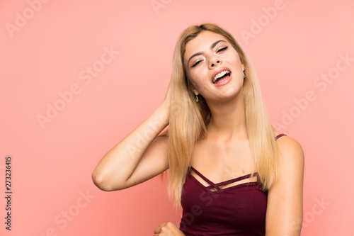 Teenager girl over isolated pink background listening something