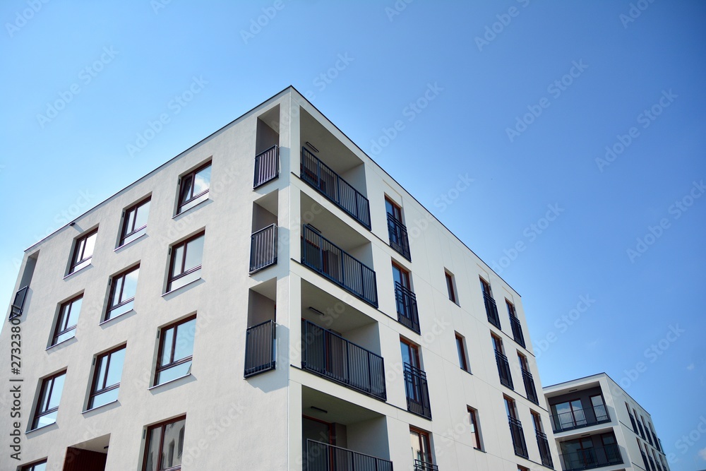 Multistory new modern apartment building. Stylish living block of flats.