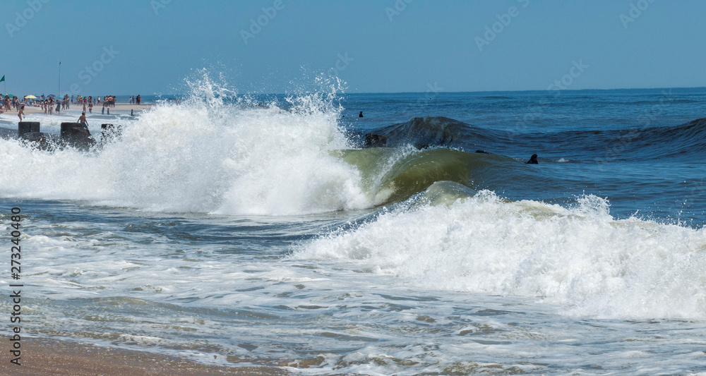 Waves crashing on beach on a summer day Waves crashing on beach on a summer day
