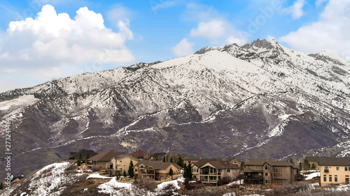 Panorama Houses on a mountain dusted with sharp white snow in winter