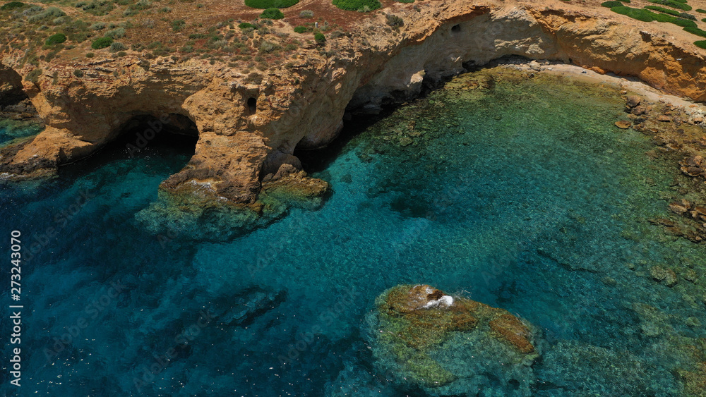 Aerial view of small islet of Ydrousa with turquoise and sapphire clear waters and only one mile distance from coast in Voula, Athens riviera, Attica, Greece Aerial view of small islet of Ydrousa with turquoise and sapphire clear waters and only one mile distance from coast in Voula, Athens riviera, Attica, Greece