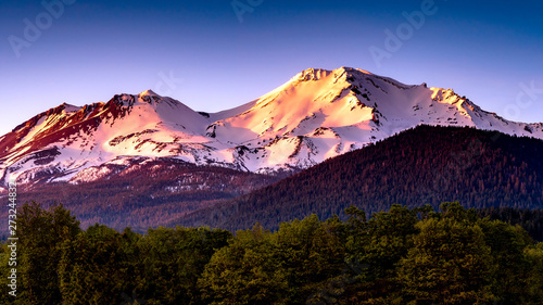 Top of Mount Shasta in the sunset on a cloudless winters day photo