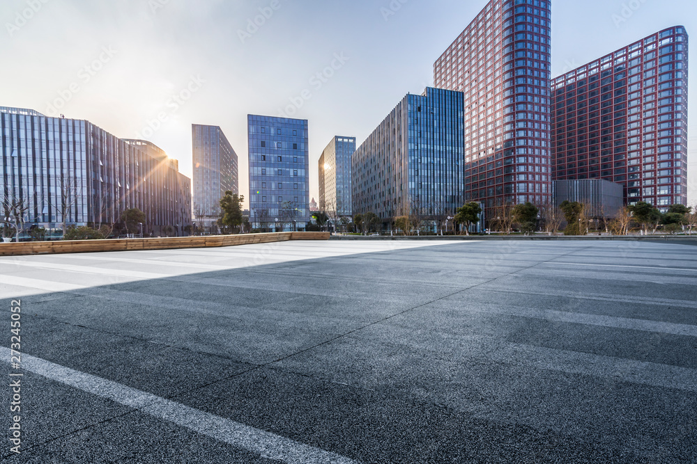 Panoramic skyline and modern business office buildings with empty road,empty concrete square floor Panoramic skyline and modern business office buildings with empty road,empty concrete square floor