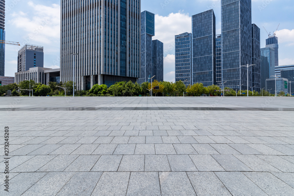 Panoramic skyline and modern business office buildings with empty road,empty concrete square floor Panoramic skyline and modern business office buildings with empty road,empty concrete square floor