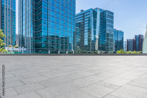 Panoramic skyline and modern business office buildings with empty road,empty concrete square floor © MyCreative