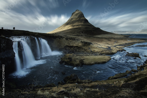 Beautiful scenery of Kirkjufell mountain and Kirkjufellfoss waterfall in Iceland is famous natural landmark and very popular for photographers and tourists. Attractions and travel concept