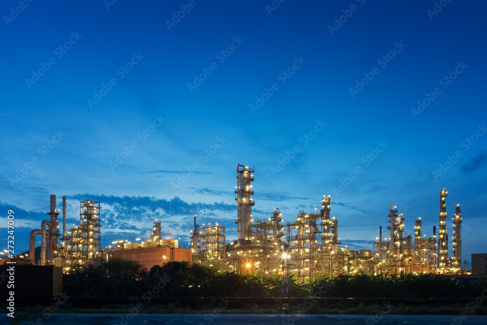 Big industrial oil tanks in a petrochemical plant at sunset