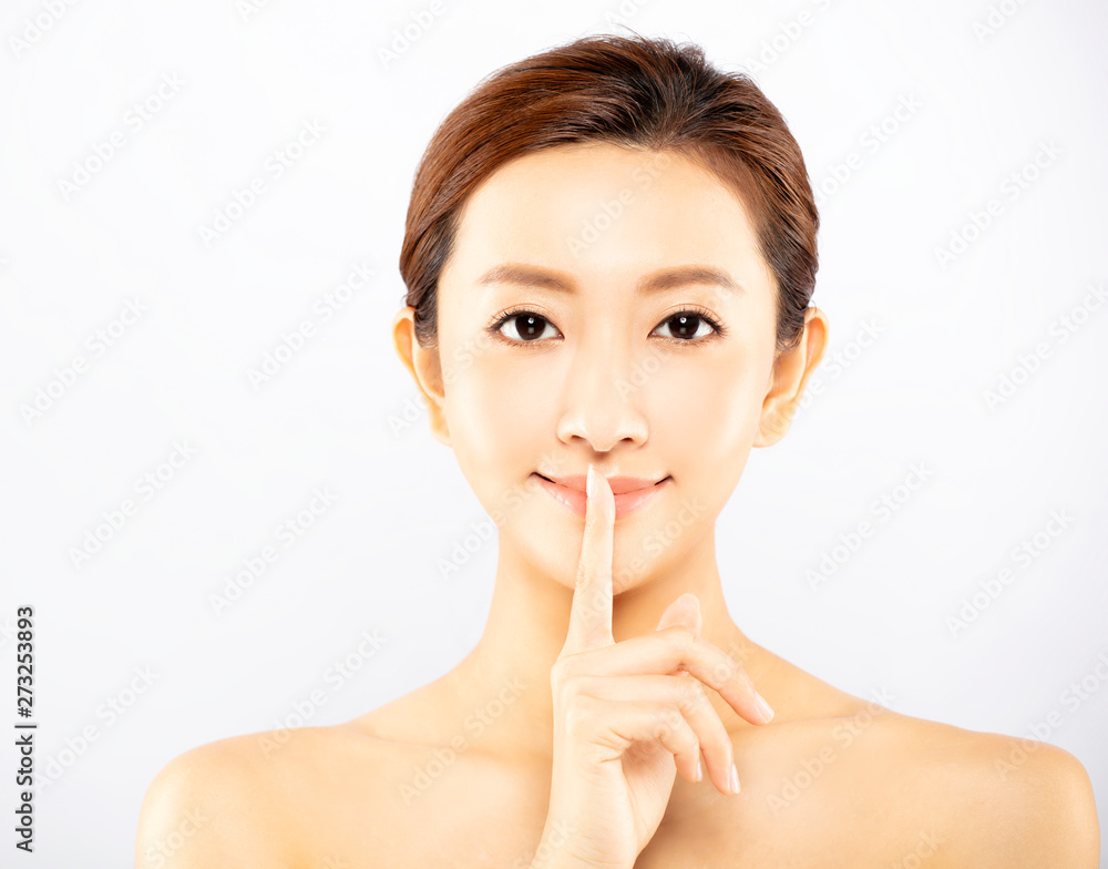 Portrait of young beauty showing silence gesture Portrait of young beauty showing silence gesture